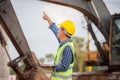 Foreman worker in hardhat with laptop at the infrastructure construction site, Engineer checking project at the building site Royalty Free Stock Photo