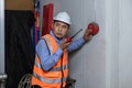 Foreman or worker pushing fire alarm on the wall. A fire! or Emergency case at the factory building. Emergency of Fire alarm or al Royalty Free Stock Photo