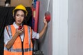 Foreman or worker pushing fire alarm on the wall. A fire! or Emergency case at the factory building. Emergency of Fire alarm or al Royalty Free Stock Photo