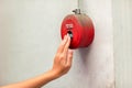 Foreman or worker pushing fire alarm on the wall. A fire! or Emergency case at the factory building. Emergency of Fire alarm or al Royalty Free Stock Photo