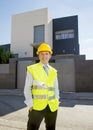 Foreman worker standing in front of new building project outdoors wearing construction helmet Royalty Free Stock Photo