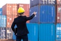 Foreman worker use a long distance radio control container cargo harbor to loading containers. Logistics import export shipping Royalty Free Stock Photo