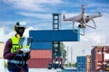 Foreman or worker use remote controller piloting drone at containers port for checking container. Foreman use remote control Drone Royalty Free Stock Photo