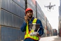 Foreman or worker use remote controller piloting drone at containers port for checking container. Foreman use remote control Drone Royalty Free Stock Photo