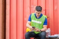 Foreman worker using mobile smartphone in industry containers cargo, Engineer man uses a mobile phone Royalty Free Stock Photo