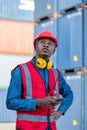 Foreman or worker work at Container cargo site hand holding mobile phone or smartphone. Foreman or worker checking on shipping con Royalty Free Stock Photo