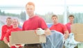 Foreman and workers with boxes of building materials