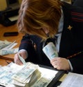 The forensic expert of the forensic center of the police conducts a study of banknotes for authenticity.