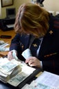 The forensic expert of the forensic center of the police conducts a study of banknotes for authenticity.