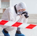 Forensic expert at crime scene doing investigation Royalty Free Stock Photo