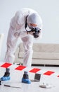 Forensic expert at crime scene doing investigation Royalty Free Stock Photo