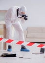 Forensic expert at crime scene doing investigation Royalty Free Stock Photo