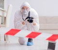 Forensic expert at crime scene doing investigation Royalty Free Stock Photo