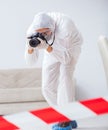 Forensic expert at crime scene doing investigation Royalty Free Stock Photo
