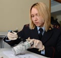 Forensic expert police pulls fingerprints found on the can of the crime scene.