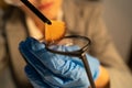 Forensic fingerprint analysis, criminalist woman collects latent fingerprints using powder on evidence glasses, copying