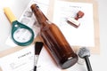 Forensic fingerprint analysis, evidence - glass bottle and fingerprint brushes in forensic laboratory