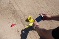 forensic hand use mobile phone take picture of evidence with evidence marker in crime scene training