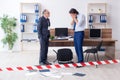 Forensic investigator investigating theft in the office Royalty Free Stock Photo