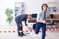 Forensic investigator investigating theft in the office Royalty Free Stock Photo