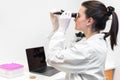 Forensic Laboratory worker studying samples with refractometer and microscope, laptop on table, Forensic science.