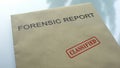 Forensic report classified, seal stamped on folder with important documents Royalty Free Stock Photo