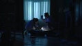 The forensic team examines the body of the victim, a murdered woman, and collects evidence using a flashlight and tongs