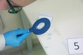 Forensic technicians taking DNA sample from blood stain with cotton swab on murder crime scene. Criminological expert collecting Royalty Free Stock Photo