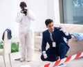 Forensics investigator at the scene of office crime Royalty Free Stock Photo