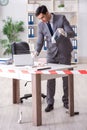 The forensics investigator at the scene of office crime Royalty Free Stock Photo