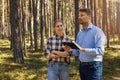 forest appraiser or buyer and owner doing property inspection and valuation