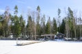 Cabin and cottages at the edge of a frozen lake in Finland.