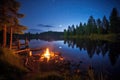 forest clearing with fishing gear, a lit fire pit, and a small lake, under night sky Royalty Free Stock Photo