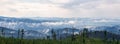 Forest with distant mountain layers and misty fog after heavy rain. Nature background. Czech landscape, nature reserve Sumava Royalty Free Stock Photo