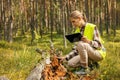 forest ecosystem. forestry worker inspecting old fallen tree, forester at work Royalty Free Stock Photo