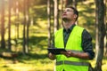 Forest evaluation and management - forestry engineer working with digital tablet