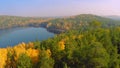 Forest in the fall lake in autumn view from the sky. Lake reflections of fall foliage. Aerial Colorful autumn foliage Royalty Free Stock Photo