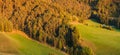 Forest and field during a bright sunset. Panoramic natural scenery for background. Dolomite Alps, Italy.