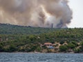 Forest fire in Croatia, summer natural disaster close to national park Krka, Sibenik region, boats and yachts escaping Skradin to