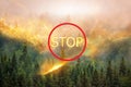 Forest on fire and smoke against the background of a red sign and the word stop the fire , global warming, forest fires in nature