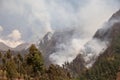 Forest fire. Smoke clouds over the forest. A forest is burning in a mountainous area Royalty Free Stock Photo