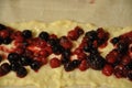 Forest fruit on vanilla cream in puff pastry.Puff pastry tart with berries and vanilla cream.Homemade preparing pie with forest fr