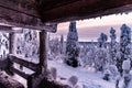 A forest fully covered with snow and a wooden bench next to it Royalty Free Stock Photo