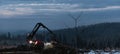 forest harvester working in an icy winter forest