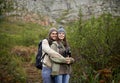 Forest, hiking and happy couple with hug, mountain and view with backpack, nature and bonding together. Outdoor Royalty Free Stock Photo