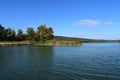 Forest lake in the autumn afternoon. Calm water with reflection of trees Royalty Free Stock Photo