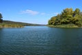 Forest lake in the autumn afternoon. Calm water with reflection of trees Royalty Free Stock Photo