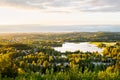 Forest and lake in Finland. Finnish nature in summer. Beautiful landscape and aerial view to town at sunset. Royalty Free Stock Photo