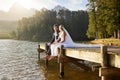 Forest, lake and a married couple on a pier in celebration together after a wedding ceremony of tradition. Marriage Royalty Free Stock Photo