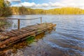 Forest lake or river on summer day and old rustic wooden dock or pier Royalty Free Stock Photo